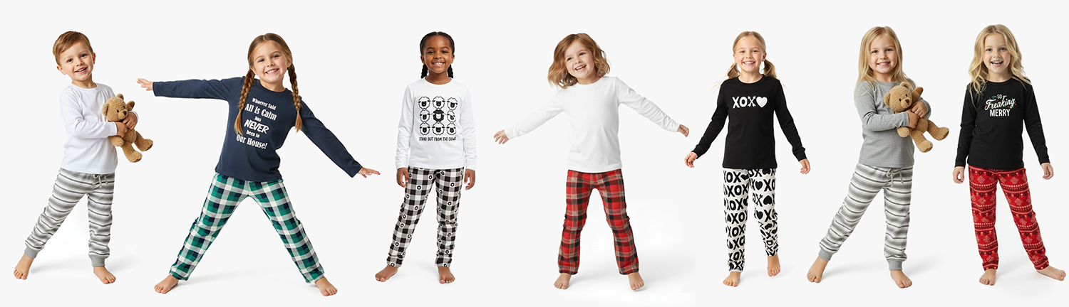 Group of smiling children modeling playful holiday pajamas with bold graphic prints, including plaids, sheep, "XOXO" patterns, and festive messages—each child showcasing a different outfit in coordinated top-and-bottom sets.